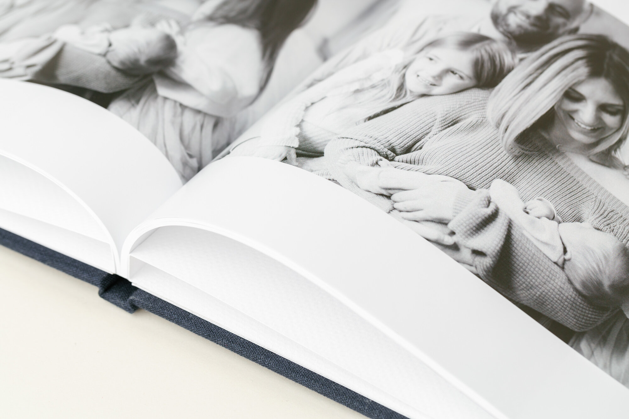 An open Hardcover Book showing a black and white family spread