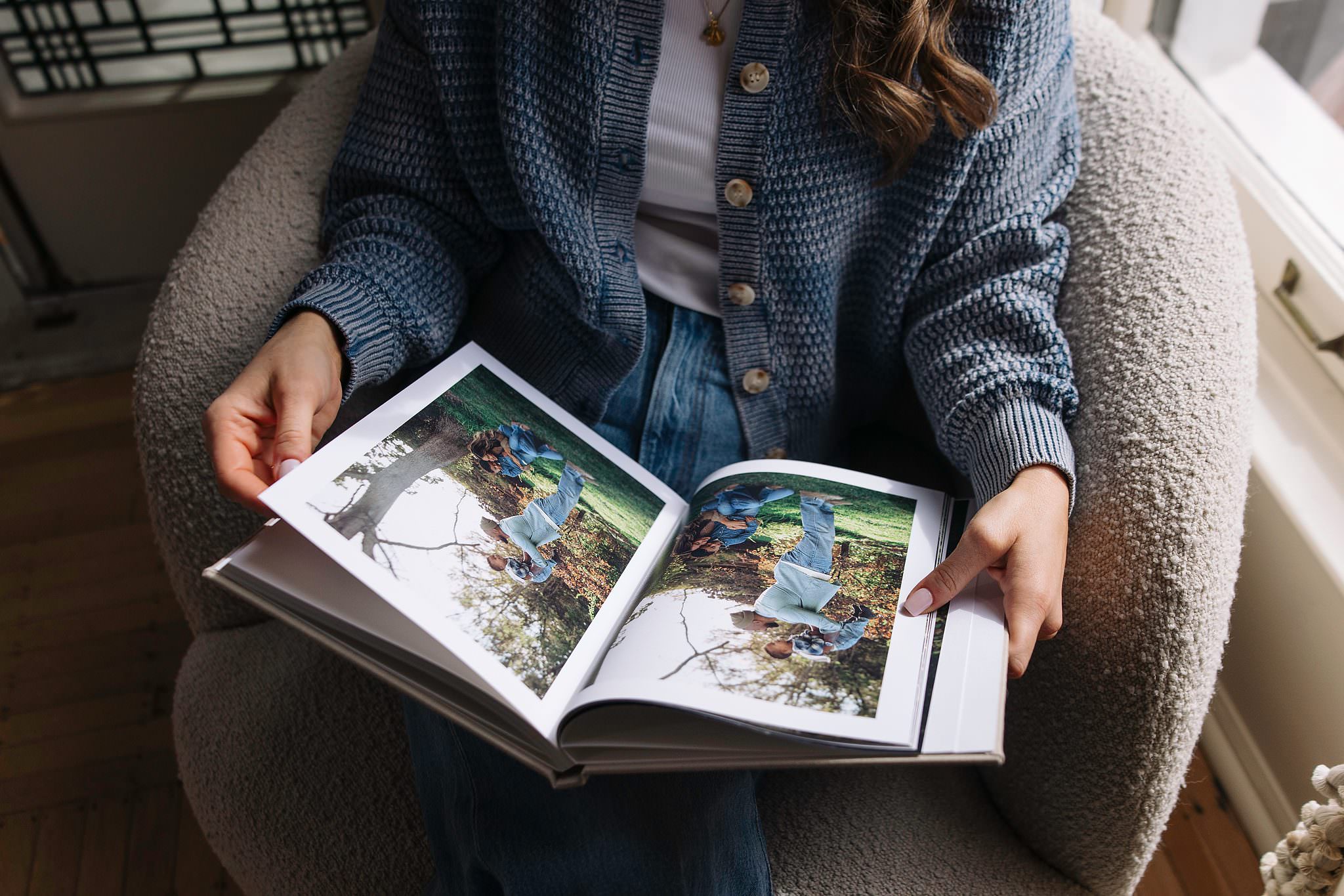 An open Hardcover Book spread resting on a reader's lap