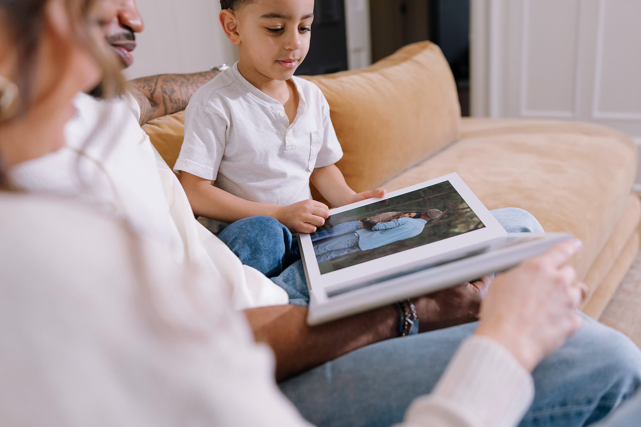 A family looking through a Lite Album on the couch
