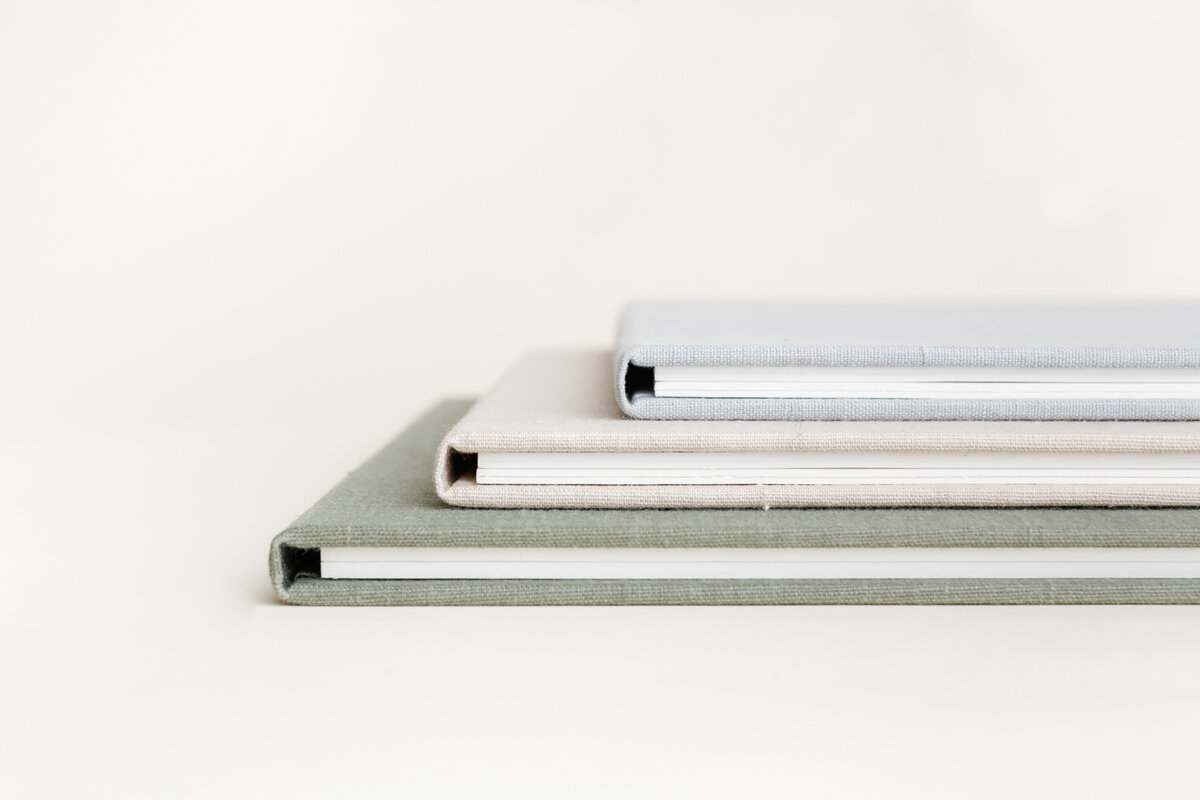 Open standing matted folio showing two side by side prints