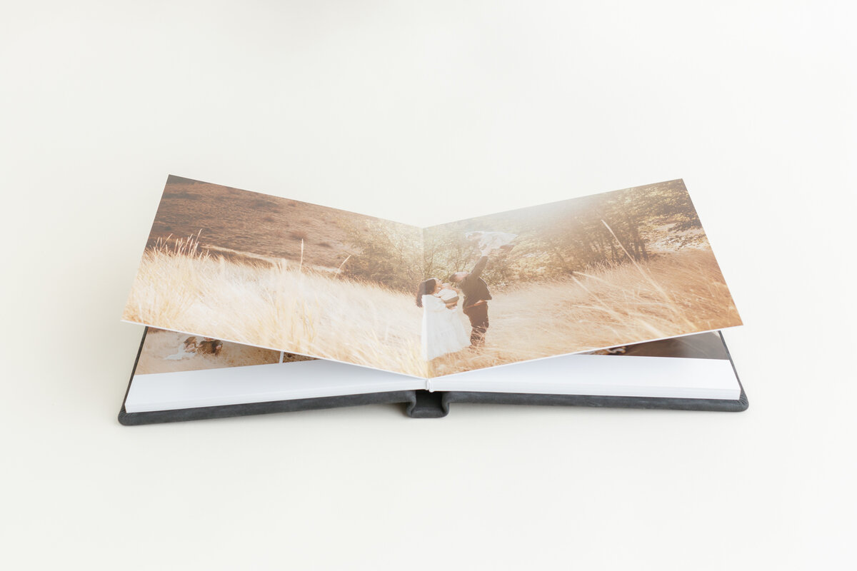 Open layflat RedTree album showing a panoramic wedding spread