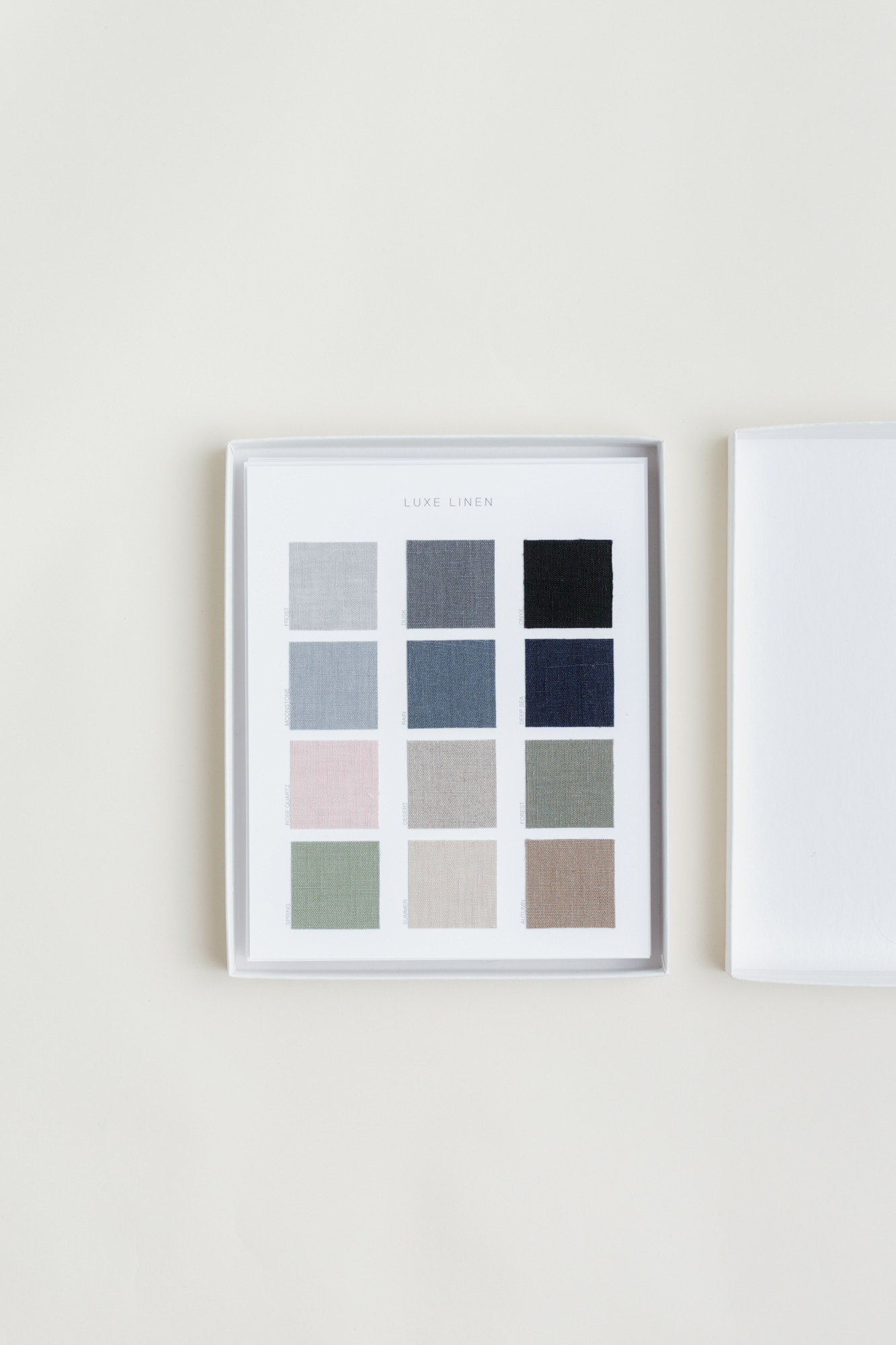 The standard swatch kit fanned open on a stone surface, showing every current cover material